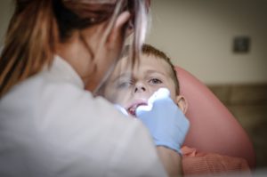 orthodontist dentist working on patients teeth