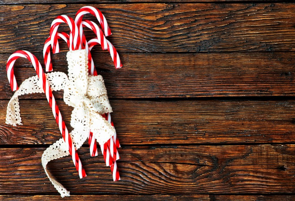 candy cane on a table - a Christmas food that is bad if you have braces